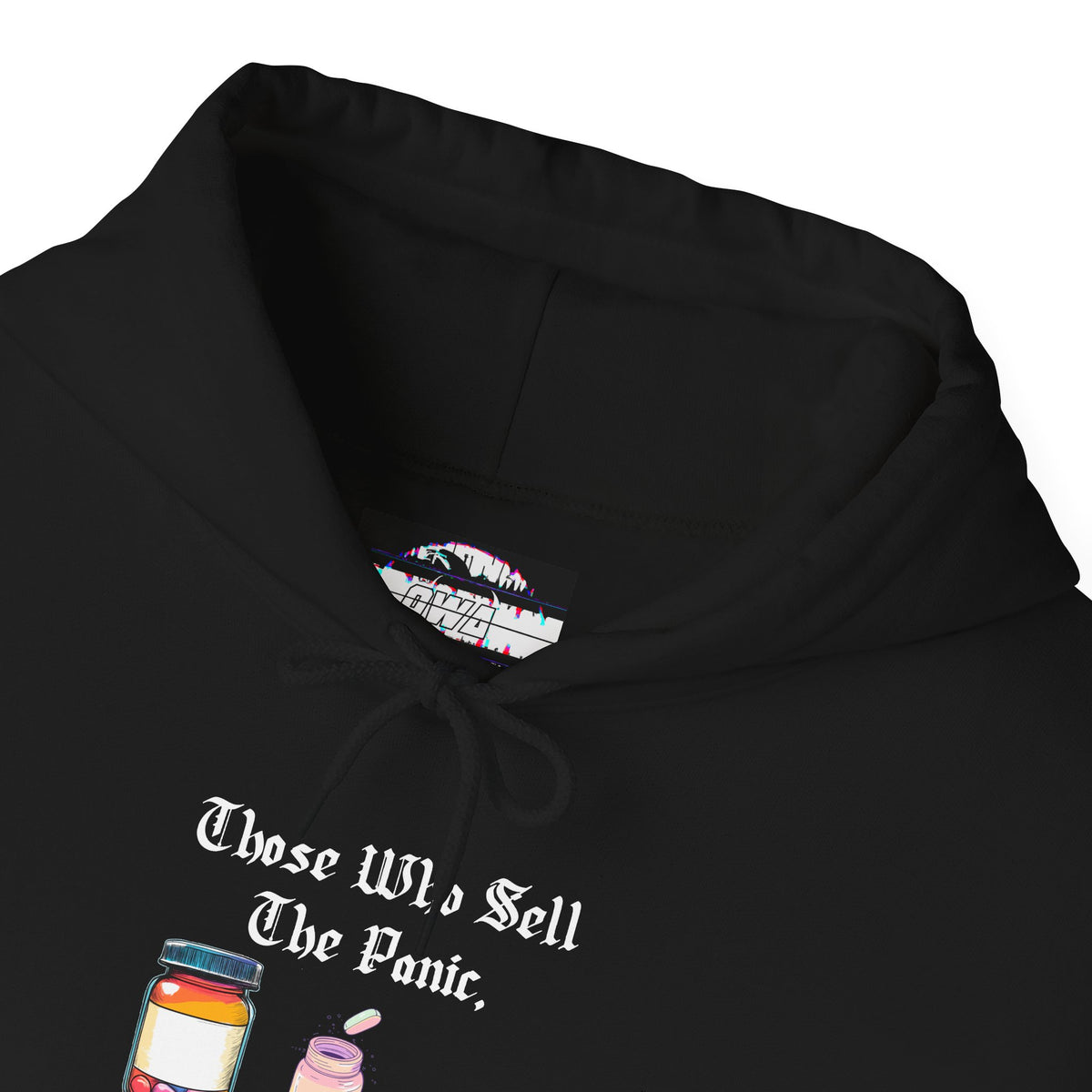 Black hoodie with gothic blackletter text “Those Who Sell the Panic, Also Sell the Cure” and three colorful pill bottles