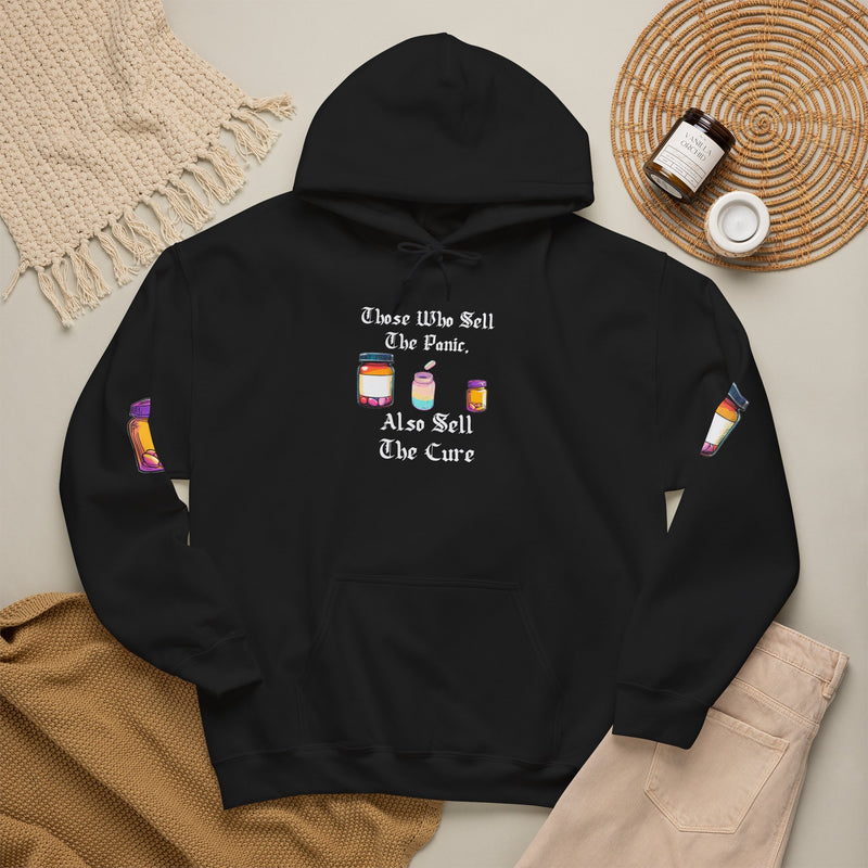 Black hoodie with gothic blackletter text “Those Who Sell the Panic, Also Sell the Cure” and three colorful pill bottles
